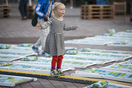 Amsterdam, The Netherlands, 12-14 September 2014, during Westival, a free open air free Cinema and culture festival on Mercatorplein. Children playing on the square before the screening startsのeditorial素材