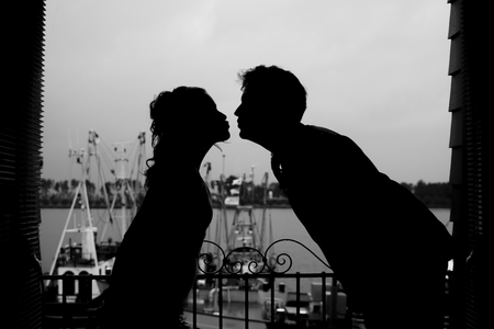 Silhouette of a couple kissingの写真素材