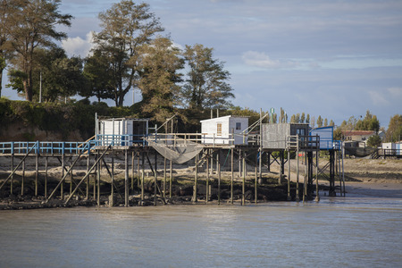 traditional french fisherman's wooden hut at the bottom of the limestone cliff in the estuary of Gironde, Meschers-sur-Girondeの写真素材