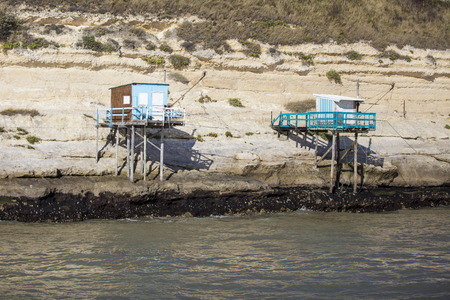 traditional french fisherman's wooden hut at the bottom of the limestone cliff in the estuary of Gironde, Meschers-sur-Girondeの写真素材