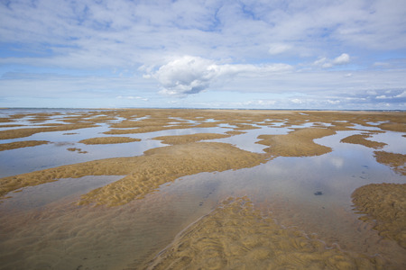 maritime seaside landscape with water, sand bank and white cloud, garonne estuary near Royan, France