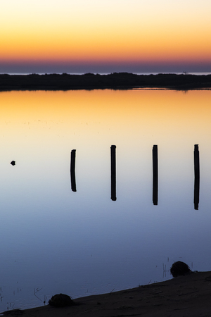 sunset with reflection in still water over nature reserve Casse de la Belle Henriette, Vendee, Franceの写真素材