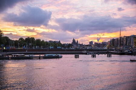 Romantic purple sunset over the Amsterdam harbour, the Netherlandsの写真素材