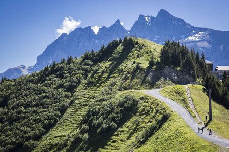 Green alpine landscape in summer, view over Swiss Alps mountain massif, Canton du Valais, Switzerlandの写真素材