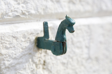 white wall with vintage shutter swing fastener in shape of a horseの写真素材