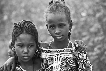 SENEGAL, Ferlo reserve, November, 2 2013: young girls in traditional outfit on the way to school.のeditorial素材