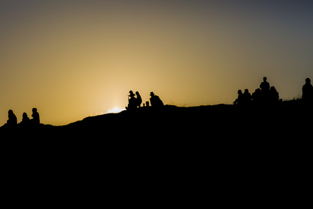 people watching the minight sun from the top of a hill at the Traenafestival, music festival taking place on the small island of Traenaの写真素材