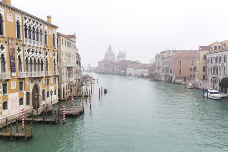 VENICE, ITALY - December 25, 2015: Grand Canal scenery in the winter fog with Santa Maria della Salute in the background, Venice, Italyのeditorial素材