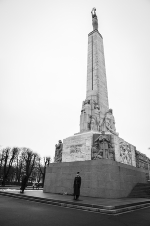 Riga, Latvia - February, 13 2016: Freedom Monument at daytime. The statue represents a woman holding three gold stars which symbolise three regions of Latvia.のeditorial素材