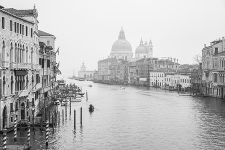 VENICE, ITALY - December 25, 2015: Black and white Grand Canal scenery in the winter fog with Santa Maria della Salute in the background, Venice, Italyのeditorial素材