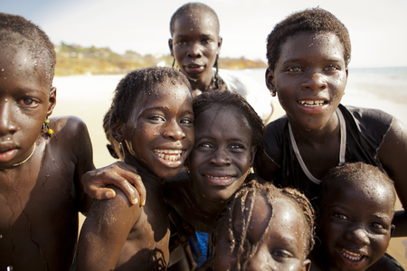 SENEGAL, Ndayane â November 9, 2013: Unidentified Senegalese children on the beach of Ndayane, playing and waiting for their father to come back from fishing . Despite poverty, Senegal kids stay smiling.のeditorial素材