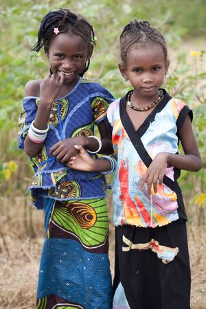 SENEGAL, Ferlo reserve, November, 2 2013: young girls in traditional outfit on the way to school.のeditorial素材