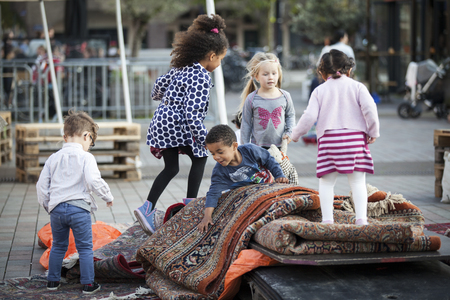Amsterdam, The Netherlands, 12-14 September 2014, during West'ival, an open air free Cinema and culture festival on Mercatorplein. Children playing on the square before the screening startsのeditorial素材