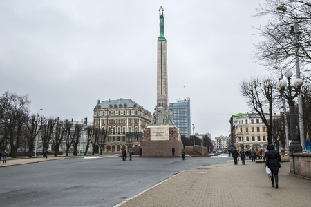 Riga, Latvia - February, 13 2016: Freedom Monument at daytime. The statue represents a woman holding three gold stars which symbolise three regions of Latvia.のeditorial素材