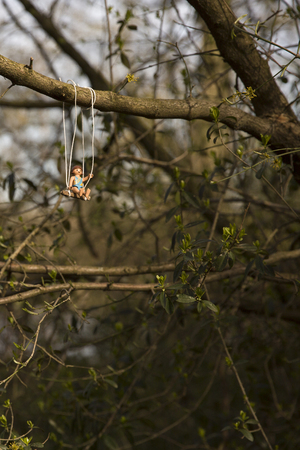 Amsterdam, the Nertherlands. April 12, 2015. Little girl having fun on a swing. Playmobil toy line exist since 1975 and is produced by the German company Brandtaetter.のeditorial素材