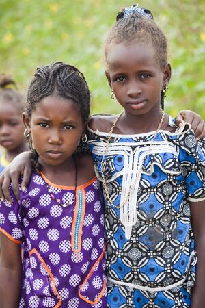 SENEGAL, Ferlo reserve, November, 2 2013: young girls in traditional outfit on the way to school.のeditorial素材