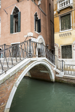 View of a small bridge over a canal, old city center of Venice, Italyの写真素材