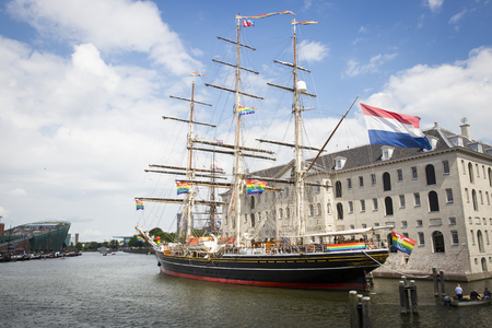 Amsterdam, the Netherlands - August 06, 2016: 3 mast sailboat Clipper Stad Amsterdam in front od the Maritime Museum Scheepvaartmuseum, participating in annual event Gay Pride Parade, Euro Pride 2016のeditorial素材