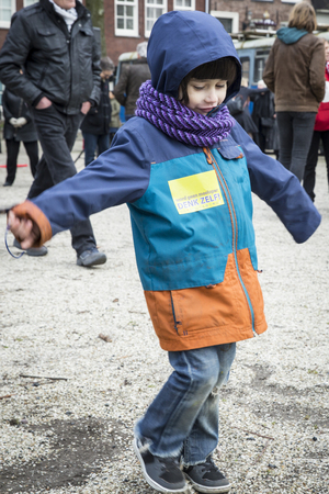 Amsterdam, The Netherlands - February 6,2016: public multi-cultural demonstration organized to protest against racism and islamophobia named "Refugees welcome, racism not!" Woman holding a sign saying later, you will be the black sheepのeditorial素材