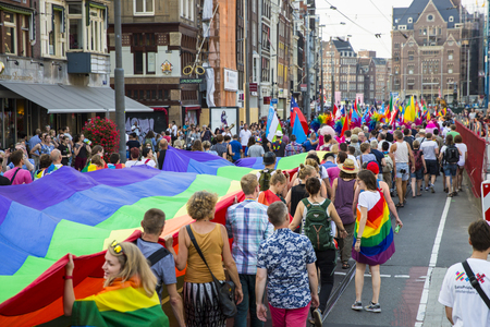 Amsterdam, the Netherlands - July 23, 2016: Pride Walk, Raimbow flag spread and held by people during the demonstration parade from Vondelpark to Dam Square during Pink Saturday Gay Euro Pride celebrationsのeditorial素材