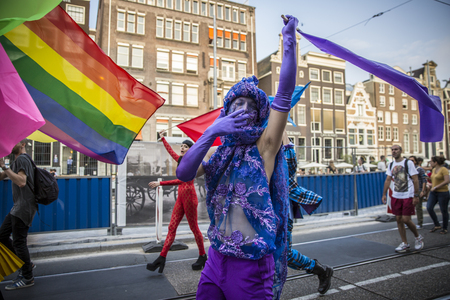 Amsterdam, the Netherlands - July 23, 2016: man dressed up in purple at Pride Walk, demonstration parade from Vondelpark to Dam Square during Pink Saturday Gay Euro Pride celebrationsのeditorial素材