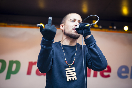 Amsterdam, The Netherlands - February 6,2016: public multi-cultural demonstration organized to protest against racism and islamophobia named "Refugees welcome, racism not!". Dutch rapper Insayno is performing to contest against racismのeditorial素材