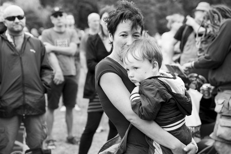 Amsterdam, The Netherlands - July, 5 2015: mother holding her young boy in her arms during Amsterdam Roots Open Air, a cultural festival held in Park Frankendael on 05/07/2015のeditorial素材