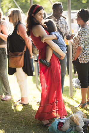 Amsterdam, The Netherlands - July, 5 2015: young mother with her daughter during Amsterdam Roots Open Air, a cultural festival held in Park Frankendael on 05/07/2015のeditorial素材