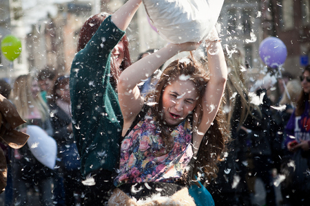 Amsterdam, The Netherlands - Saturday, April 5 2014 - young woman fighting at the Pillow Fight on Dam Squareのeditorial素材
