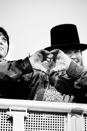 Traena, Norway - July 12: woamn in audience doing a heart shape with her hand during the concert of the Norwegian folk and rock Ã¢ï¿½ï¿½Violet RoadÃ¢ï¿½ï¿½ at the Traenafestival, music festival taking place on the small island of Traena in Norway.のeditorial素材