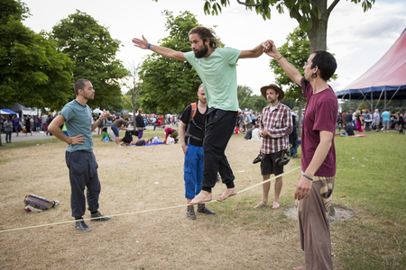 Amsterdam, The Netherlands - July, 5 2015: tightrope walking workshop during Amsterdam Roots Open Air, a cultural festival held in Park Frankendael on 05/07/2015のeditorial素材