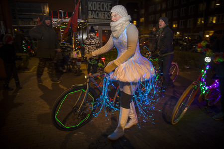 Amsterdam, The Netherlands - 06 January 2017: arrival of the cyclists participating in "Light My Ride", an event where participants ride in Amsterdam with their pimped bike.のeditorial素材