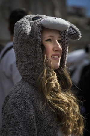 Amsterdam, The Netherlands, Noord Holland - Saturday, April 4 2015 Ã¢ï¿½ï¿½ Young girl with sheep costume participating in the Pillow Fight on Dam Square. This event is part of the international pillow fight day held in several cities in the worldのeditorial素材