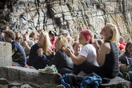 Traena, Norway - July 12 2014: during the concert of the Norwegian Singer Stein Torleif Bjella featuring Svartlamon Hardkor choir at cathedral cave of Kirkehelleren on Sana Isaland at the Traena music festivalのeditorial素材