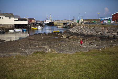 Traena, Norway - July 10 to 12 2014: the port with a few fishing boat and the ferry bringing people from the continent for the Traenafestival, music festival taking place on the small island of Traenaのeditorial素材