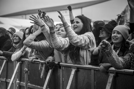 Traena, Norway - July 9 2015: fans cheering with arms up at concert of Norwegian rock band OnklP & De Fjerne Slektningene at Traenafestival, music festival taking place on the small island of Traenaのeditorial素材