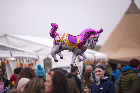 Traena, Norway - July 10 2015: people in the audience with little poney shaped balloon floating in the air, at Traenafestival, music festival taking place on the small island of Traenaのeditorial素材