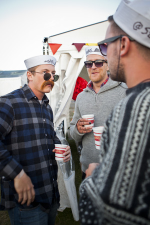 Traena, Norway - July 11 2014: people watching the concert of the Swedish pop-techno band Den Svenska Bjornstammen at the Traenafestival, music festival taking place on the small island of Traenaのeditorial素材