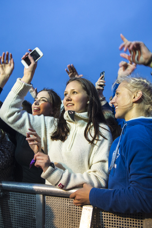 Traena, Norway - July 9 2015: fans cheering with arms up at concert of Norwegian rock band OnklP & De Fjerne Slektningene at Traenafestival, music festival taking place on the small island of Traenaのeditorial素材
