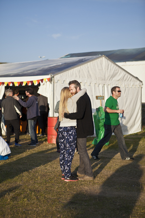 Traena, Norway - July 10 to 12 2014: happy young couple kissing each other, Traenafestival, music festival taking place on the small island of Traenaのeditorial素材