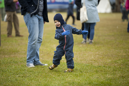 Traena, Norway - July 10 2015: little boy having fun and dancing on the festival field Traenafestival, music festival taking place on the small island of Traenaのeditorial素材