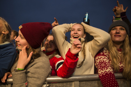 Traena, Norway - July 9 2015: fans cheering with arms up at concert of Norwegian rock band OnklP &...