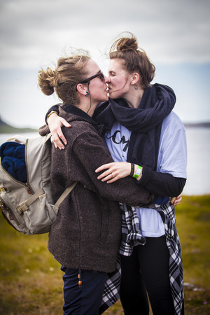Traena, Norway - July 11 2015: two young women kissing during the smallest gay Pride in Europe during Traenafestival, music festival taking place on the small island of Traena.のeditorial素材