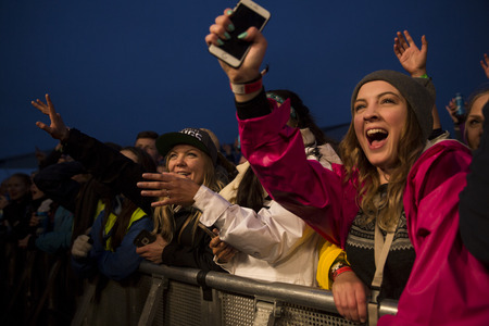 Traena, Norway - July 9 2015: fans cheering with arms up at concert of Norwegian rock band OnklP &...