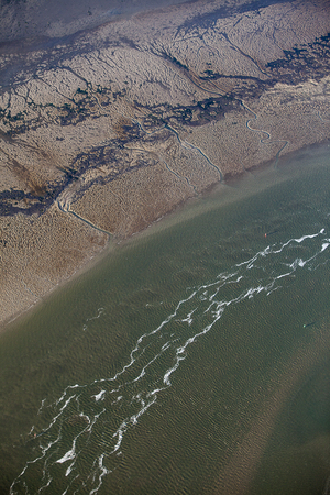aerial view of estuary mudflat wetland of the shore of Ameland island in the reflecting sunset, The Netherlandsのeditorial素材