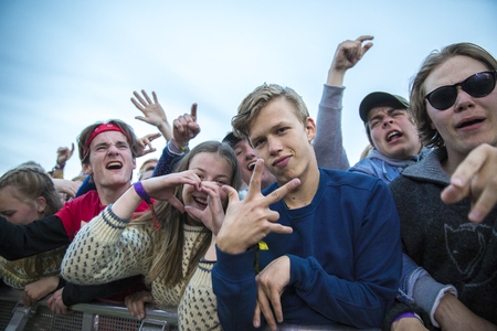 Traena, Norway - July 7 2017: young people cheering in the audience during concert of Norwegian rap band Sushi X Kobe at Traenafestival, music festival taking place on the small island of Traenaのeditorial素材