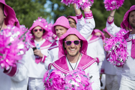 Traena, Norway - July 07 2017: men from the choir Oslo Fagottkor in their pink uniform participating...