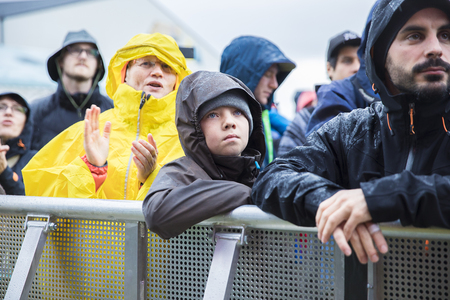 Traena, Norway - July 7 2017: amazed and admirative kid in the audience under the rain during concert of Norwegian pop singer Aurora at Traenafestival, music festival taking place on the small island of Traenaのeditorial素材