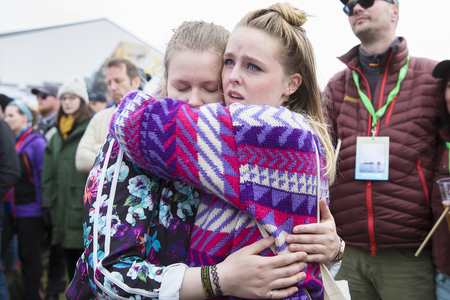 Traena, Norway - July 7 2017: 2 girls hugging with emotion during the concert of Norwegian gay choir Oslo Fagittkor at Traenafestival, music festival taking place on the small island of Traenaのeditorial素材