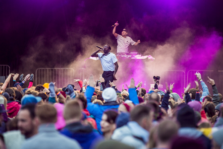 Photo for Traena, Norway - July 8 2017: concert of Norwegian rap hiphop band African Sunz at Traenafestival, music festival taking place on the small island of Traena - Royalty Free Image